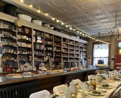 A long dining table set for a meal inside a large room.